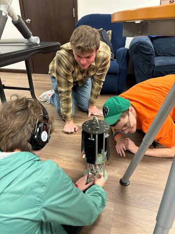 Team giving STEM demonstration to local students